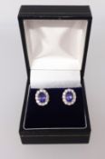 A pair of 18ct tanzanite and diamond cluster earrings.