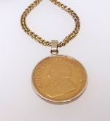 A coin pendant necklace set with 1oz Krugerrand mounted, the chain 96cm long, 18ct, gross weight