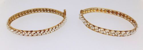 Two high carat yellow gold bangles set throughout with pearls, approx 21.4gms.