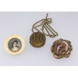 A Victorian mourning brooch, a gilt metal locket and chain and a miniature portrait of a Lady in a