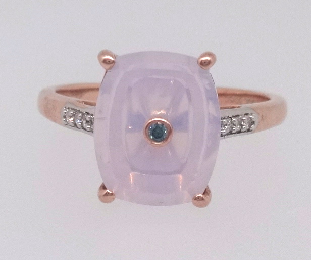 Lehrer, a Torus Ring set with a small blue diamond in 10k rose gold, the shank signed and numbered