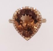 A 14k yellow gold and diamond ring set with a pear cut champagne topaz approx 7.43ct, diamonds