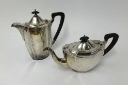 A modern silver tea and coffee pot, of fluted design with carved finials, approx 43.5oz.