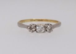 An 18ct diamond three stone ring, finger size N.