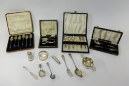 A mix of various silverwares including silver teaspoons, baby spoon and feeder, napkin ring, small