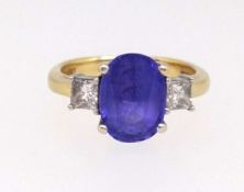 A tanzanite and diamond three stone ring, the centre stone approx 2.26ct, princess cut diamonds each