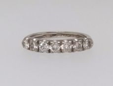 A diamond half eternity ring, seven round brilliant cut diamonds mounted in all white gold claw