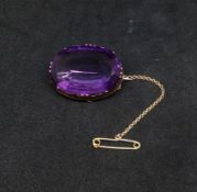 Large oval amethyst and yellow metal brooch