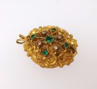 A Victorian gold emerald and diamond set brooch of open scroll work design the reverse with a glazed