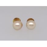 A pair of cultured pearl stud earrings, mounted in yellow metal threaded post fittings for pierced