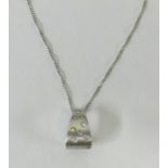 A 18ct white gold pendant, comprising a scattering of small round brilliant cut yellow, white and