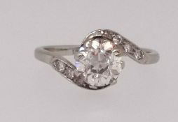 A single stone diamond ring of twist design set with an old cushion round cut diamond on diamond