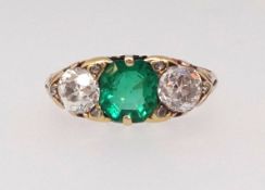 A good antique emerald and diamond three stone ring set in yellow gold unmarked, finger size L.