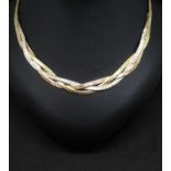 A 9ct three colour gold collar, centre section comprising entwined yellow, white and rose gold brick