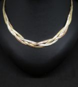 A 9ct three colour gold collar, centre section comprising entwined yellow, white and rose gold brick