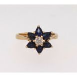 A 18ct diamond and sapphire cluster ring, finger size K.