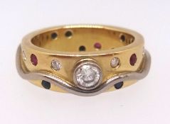 An 18ct yellow gold and multi stone contemporary design ring set with diamonds, sapphires, ruby's