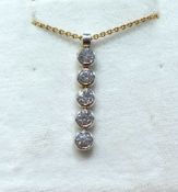 An 18ct white gold and diamond five stone pendant necklace.