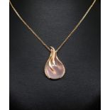 A 18ct rose gold pendant comprising a pink cabochon cut quartz mounted in a rose gold setting with
