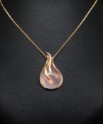 A 18ct rose gold pendant comprising a pink cabochon cut quartz mounted in a rose gold setting with