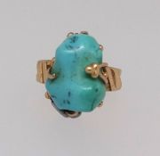 A turquoise matrix dress ring, mounted in abstract yellow gold setting with split yellow gold shank,
