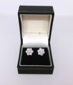 Pair of diamond cluster earrings each set with seven diamonds in white and yellow gold, diameter