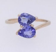 A modern tanzanite dress ring set in yellow gold, stamped 10k, finger size O.