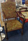 A Victorian carved elbow chair with needlework seat.