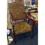 A Victorian carved elbow chair with needlework seat.