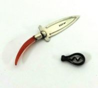 A silver and coral handle page marker and a miniature corkscrew.
