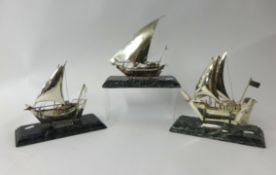 Three Danish silver ship models on marble bases, height 21cm.