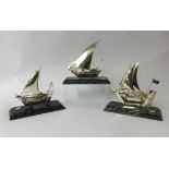 Three Danish silver ship models on marble bases, height 21cm.