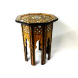 A Moroccan style occasional octagonal table with marquetry and mother of pearl decoration.