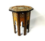 A Moroccan style occasional octagonal table with marquetry and mother of pearl decoration.