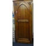 An oak single door wardrobe of gothic design.