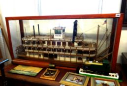 A model of a Mississippi paddle steamer in glazed cabinet, length including cabinet 112cm, height