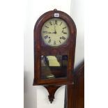 A Victorian walnut wall clock.