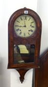 A Victorian walnut wall clock.