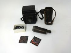 An assortment of cameras, binoculars etc including Junior Special antique camera, box of slides