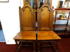 A set of six heavy oak dining chairs of gothic design.