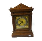 Oak cased mantle clock with double gong strike and eight day movement.