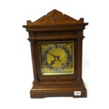 Oak cased mantle clock with double gong strike and eight day movement.