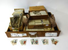 A large collection of cigarette cards and postcards including real photographic postcards, also