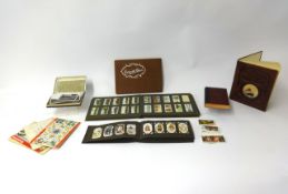 A large collection of cigarette cards and postcards, various sets in albums and loose.