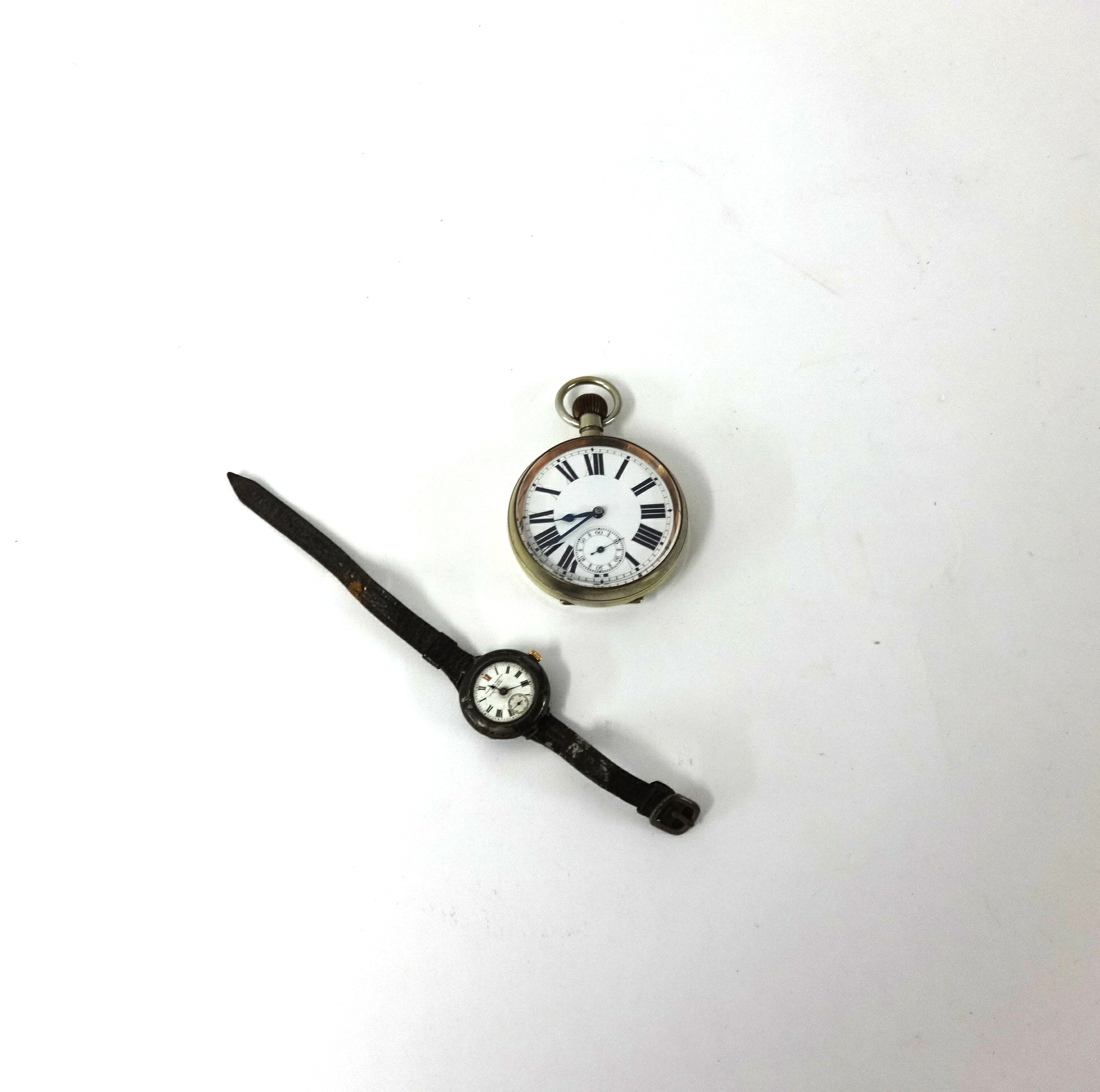 A large nickel open face pocket watch, keyless movement together with a vintage wristwatch by West