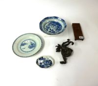 An oriental bronzed dragon, four blue and white dishes (faults).