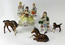 A collection of various porcelain figurines including miniatures and Beswick horses.