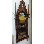 A gothic style carved wood mirror