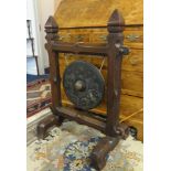 A oriental dinner gong in carved wood frame, height 90cm.