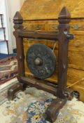 A oriental dinner gong in carved wood frame, height 90cm.